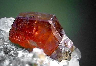 Garnet is not a single mineral but a group of silicate minerals that occur in different colors such as red, orange, green, and purple. Garnets are among the most common gemstones formed during metamorphism.